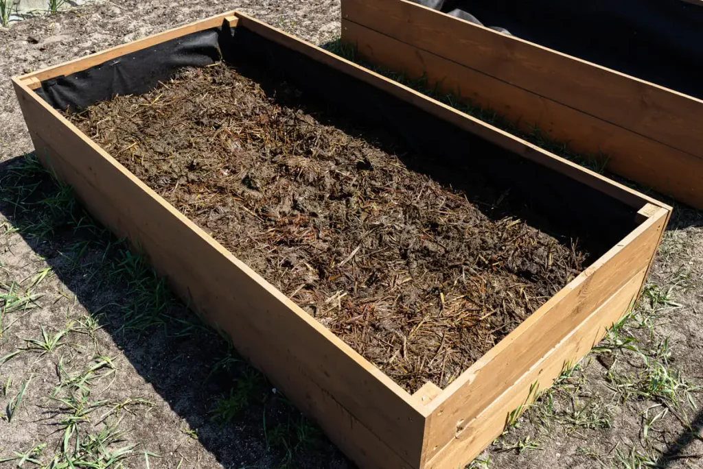 filling a raised bed with organic mix
