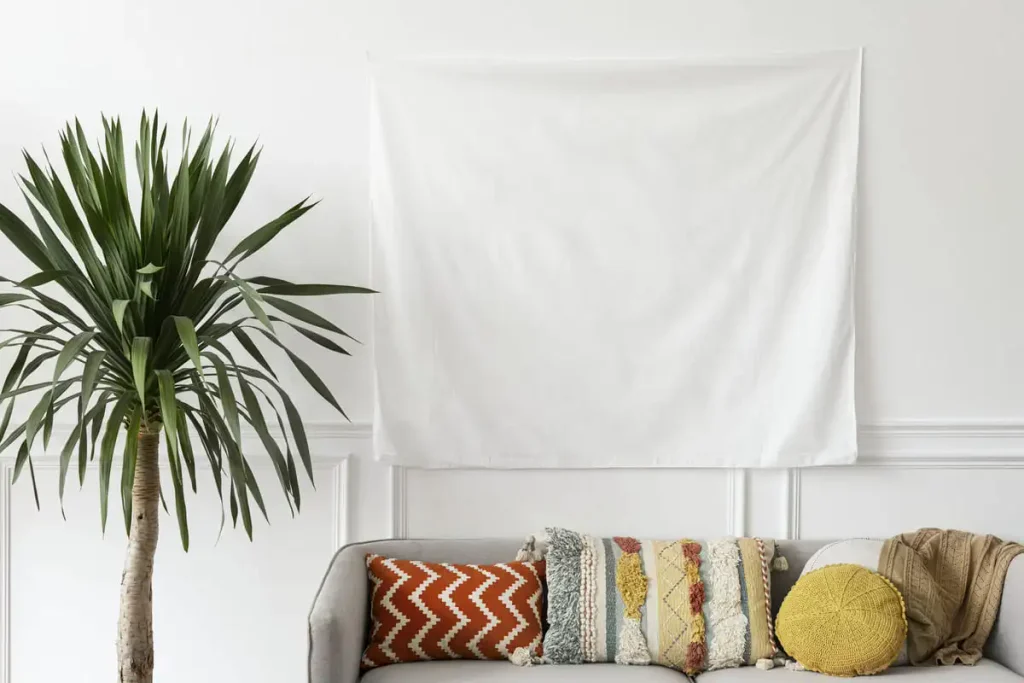 Bohemian living room wall with layered pattern throw pillows in rust, sage, and mustard tones beside a potted palm
