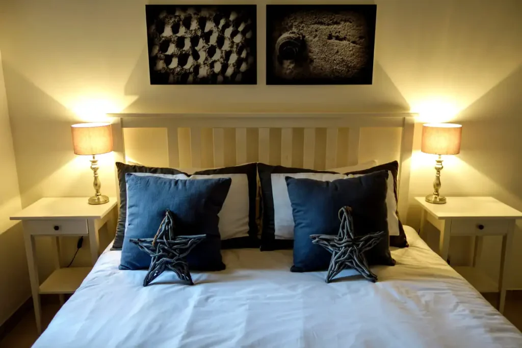 Bed made up with dark blue pillows and star-patterned bedding
