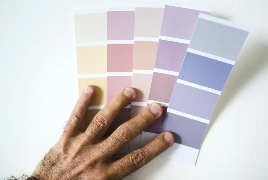 Man holding paint swatches to choose a wall color