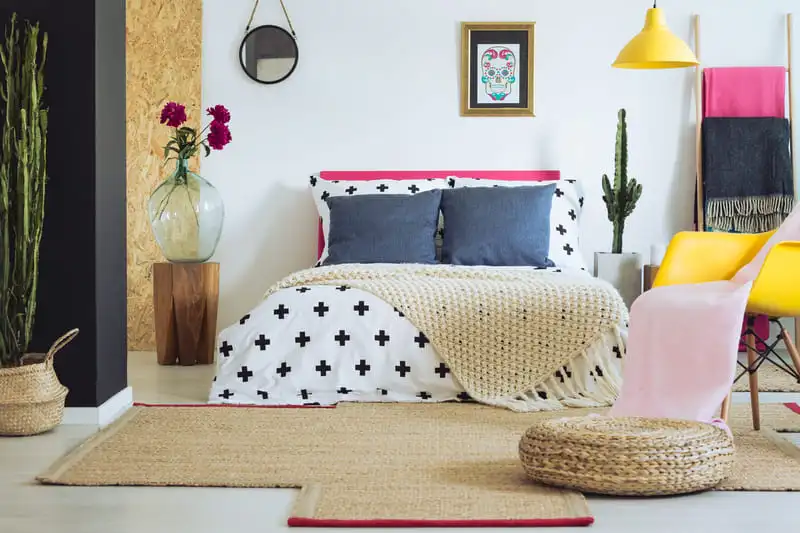 Multicolored folk-style bedroom with saturated textiles