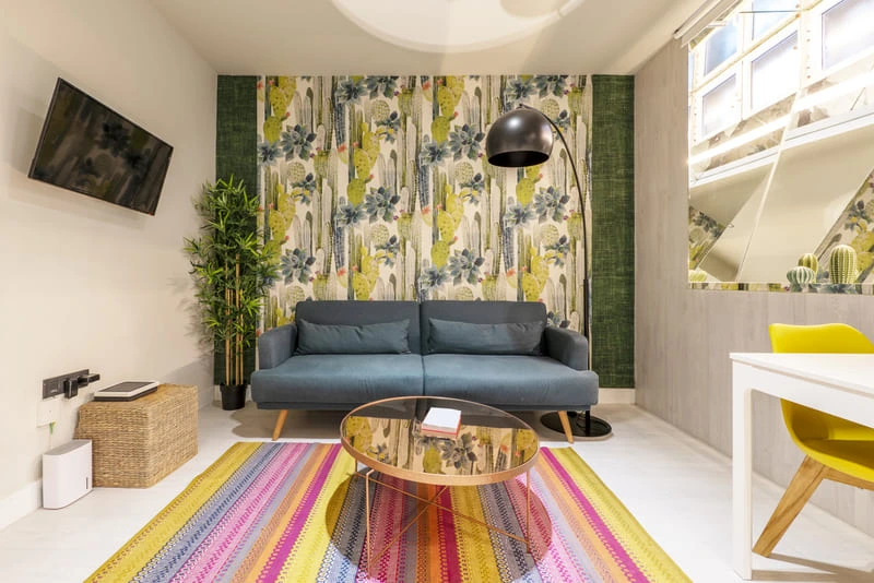 Dopamine decor bedroom with colorful walls, patterned rugs, and vibrant accessories