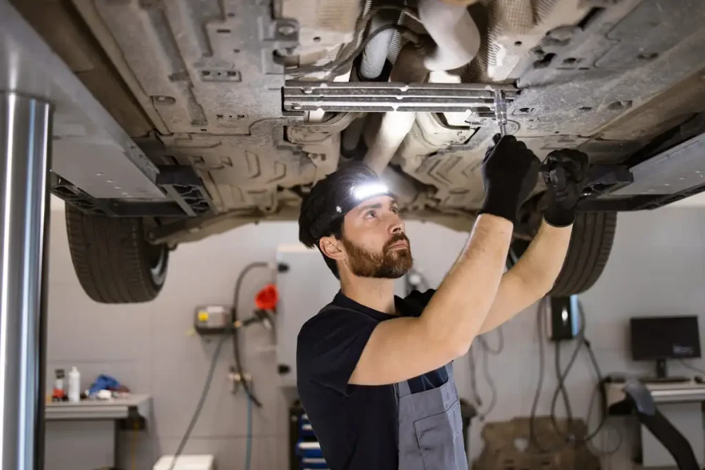 Garage lighting ideas with overhead lights distributed across a vehicle workspace