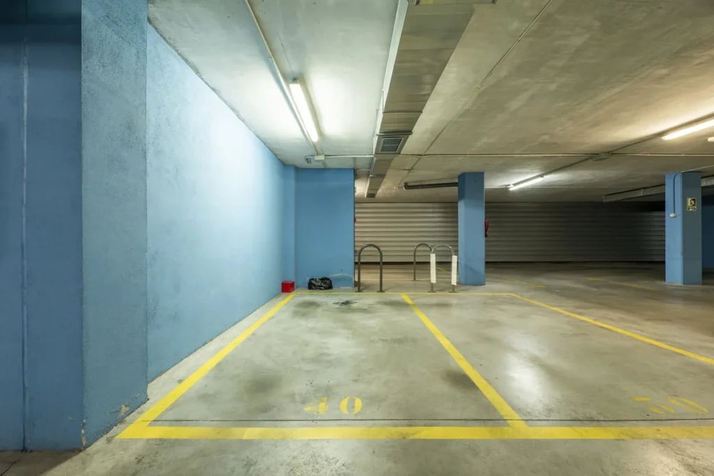 Garage paint ideas shown with a gray concrete floor and soft blue painted walls