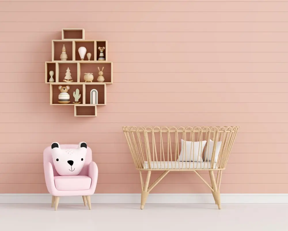 Soft pink kids room with a bear cushion armchair and wall shelf, a gentle starting point for hello kitty room ideas