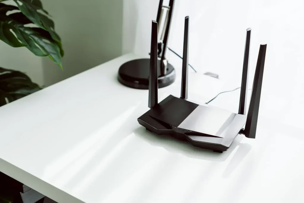 Wi-Fi router on a table at home that connects smart bulbs to the network