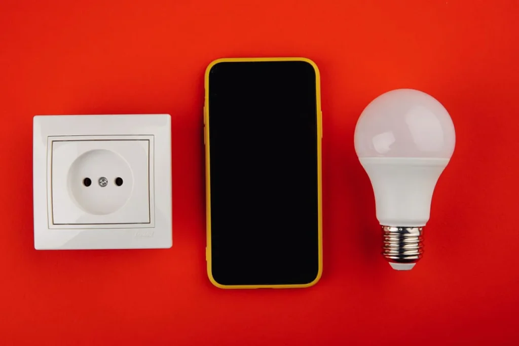 Smart home automation device next to a smart bulb and socket