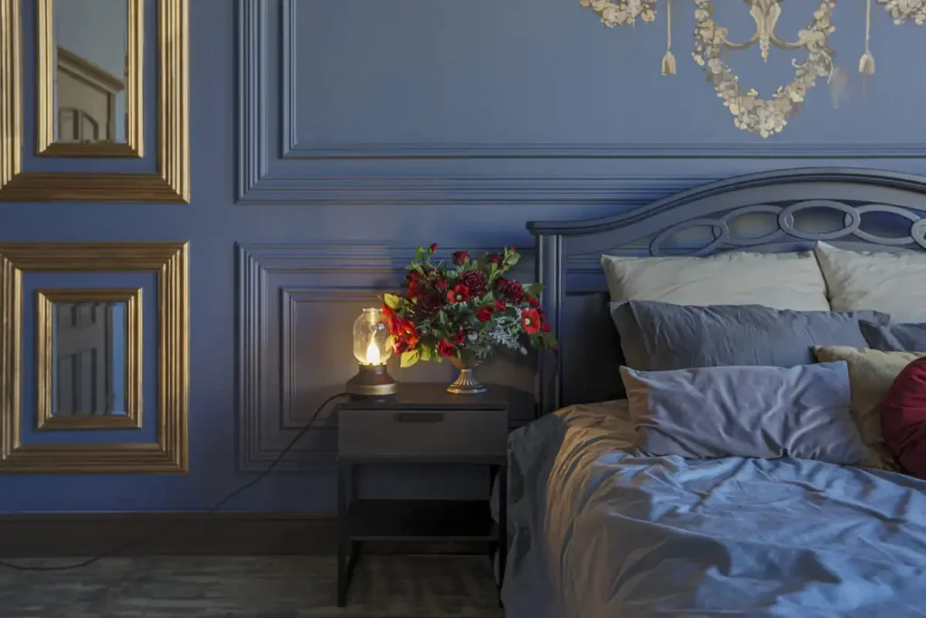 Deep blue bedroom with antique wood furniture and gold details